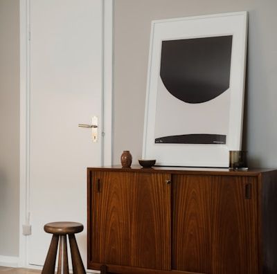 a room with a wooden cabinet and a picture on the wall