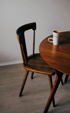 white ceramic mug on brown wooden table